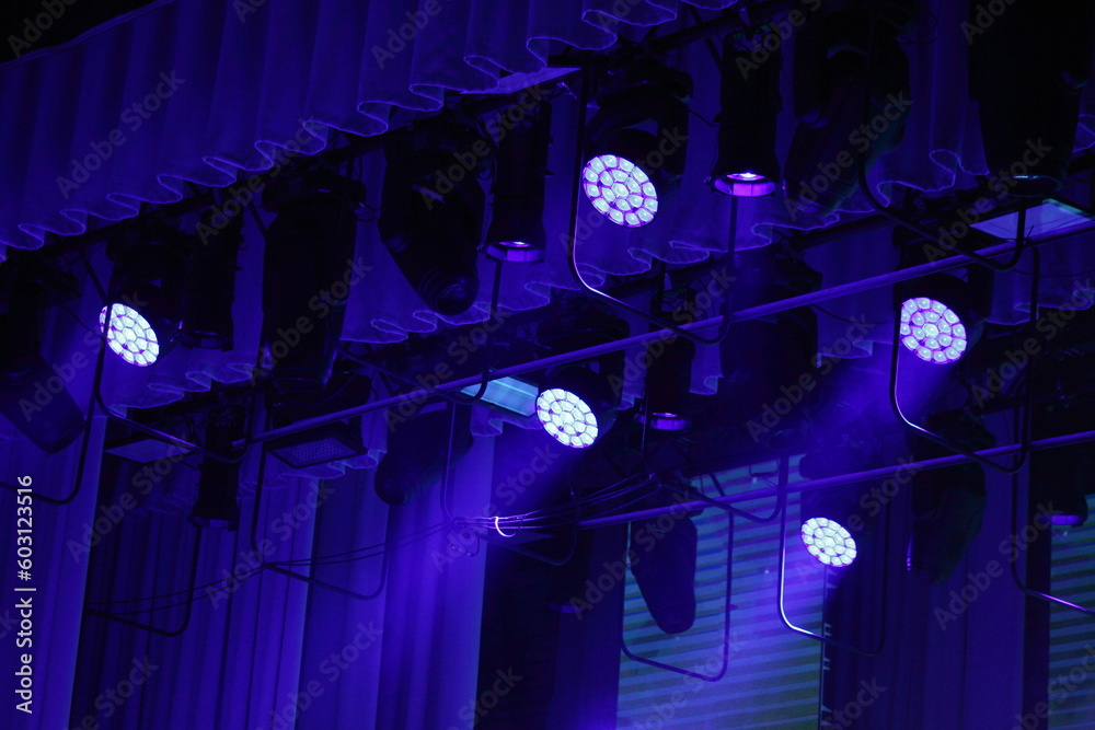 Blue spotlights on top stage lighting. - obrazy, fototapety, plakaty 