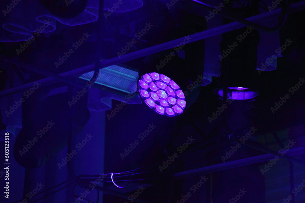 Violet spotlight on top stage light in darkness - obrazy, fototapety, plakaty 