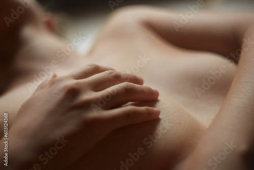 Woman with her hand over her breast 