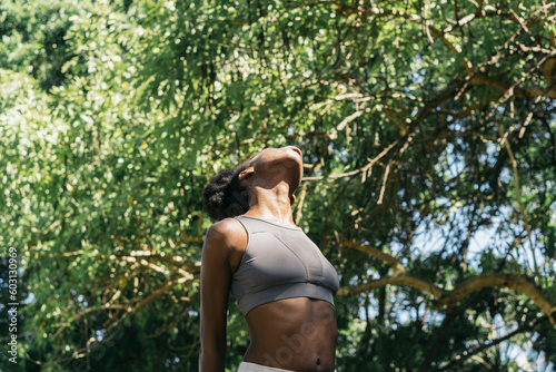 Exercising body and mind, woman doing yoga in the park.