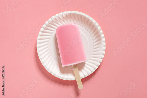 fruit ice cream popsicle on apink background. creative composition photo