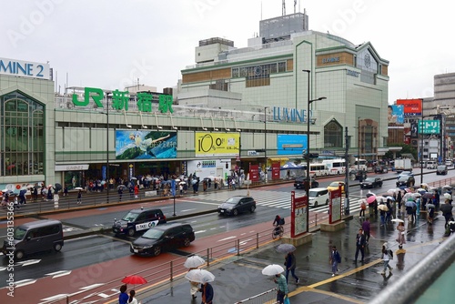 Shinjuku Ward, Tokyo, May 2023.People with umbrellas at the south exit of Shinjuku in the rain.