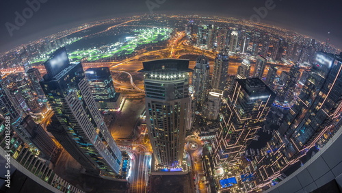 Panorama of Dubai Marina with JLT skyscrapers and golf course day to night timelapse  Dubai  United Arab Emirates.