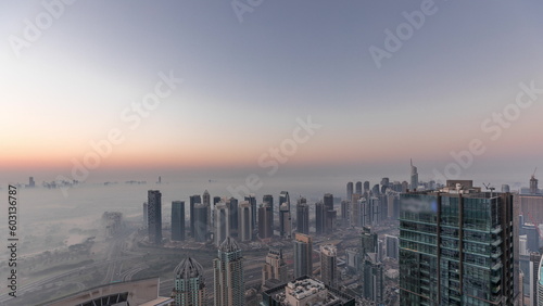 Panorama of Dubai Marina with JLT skyscrapers and golf course night to day timelapse, Dubai, United Arab Emirates.