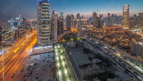 Dubai s business bay towers aerial day to night timelapse. Rooftop view of some skyscrapers
