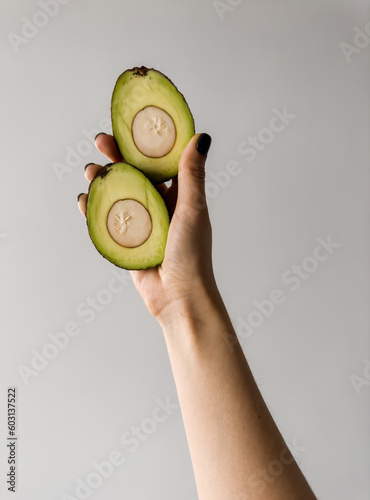Sliced avocado in hand  photo