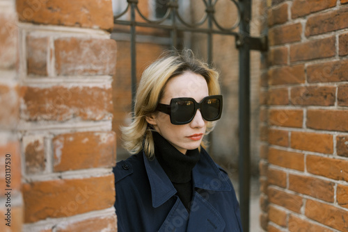 Woman with sunglasses on the street in closeup photo