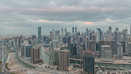Skyline with modern architecture of Dubai business bay towers night to day timelapse. Aerial view © neiezhmakov