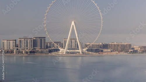 Bluewaters island with modern architecture and ferris wheel covered by morning fog aerial timelapse. © neiezhmakov