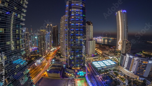 Panorama of the Dubai Marina and JBR area and the famous Ferris Wheel aerial day to night timelapse © neiezhmakov