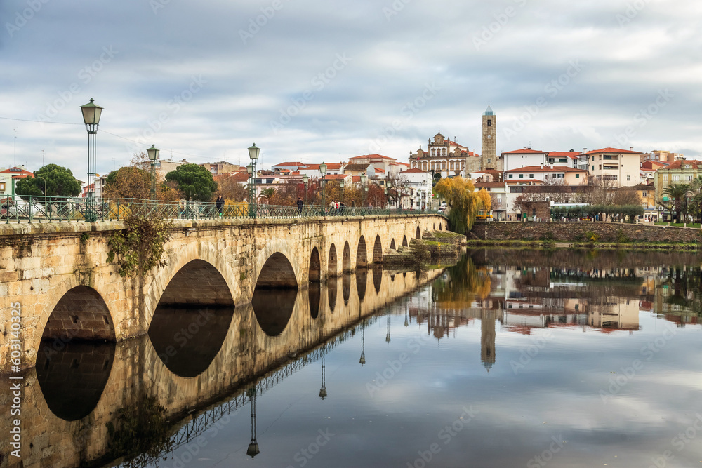 Beautiful landscape of the city of Mirandela, in Portugal, with the medieval bridge and the Tua river in the foreground, on an autumn morning.
