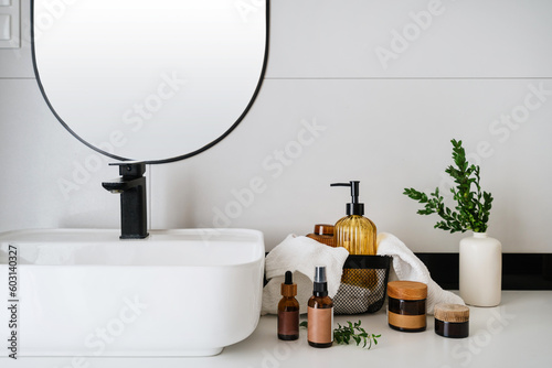 Fotografija beauty products for skin care near washbasin in bathroom