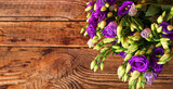 Bouquet of beautiful eustoma flowers on wooden background with space for text, top view