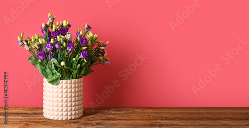 Fototapeta Naklejka Na Ścianę i Meble -  Vase with beautiful eustoma flowers on table near red wall. Banner for design