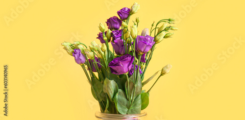 Bouquet of beautiful eustoma flowers on yellow background