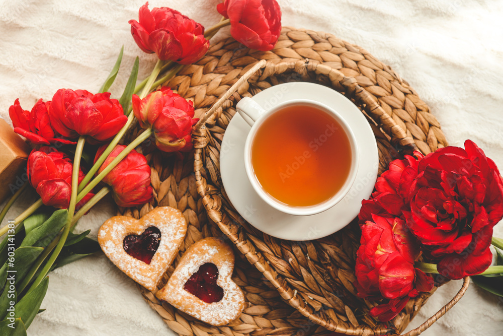 Tray with tasty breakfast, bouquet of peonies and gift for Valentine's Day on bed Tray with tasty breakfast, bouquet of peonies and gift for Valentine's Day on bed