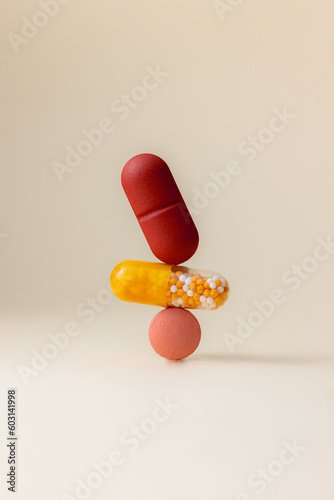 Yellow and red supplement pills photo