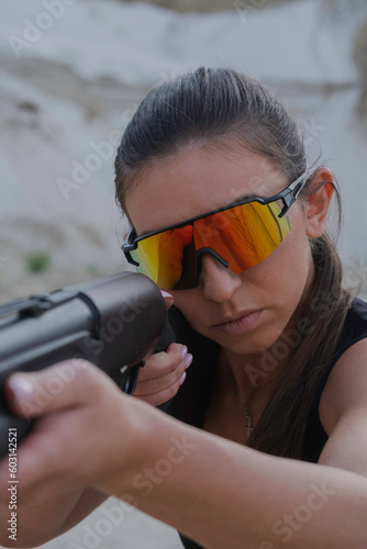 Woman with shotgun  take aim.  photo