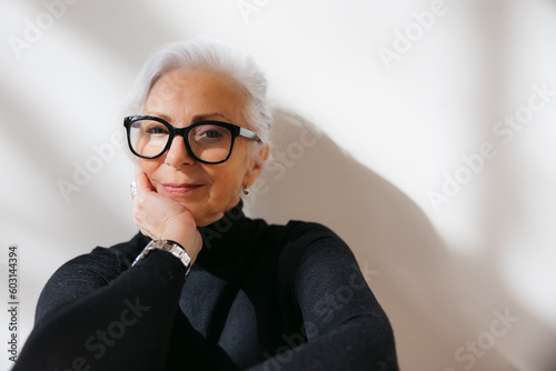Woman in simple studio with serious expression. photo