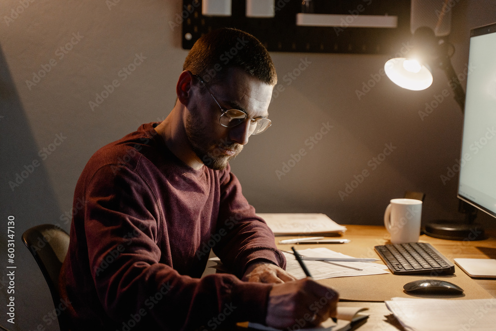 A man works in office at night A man works in office at night