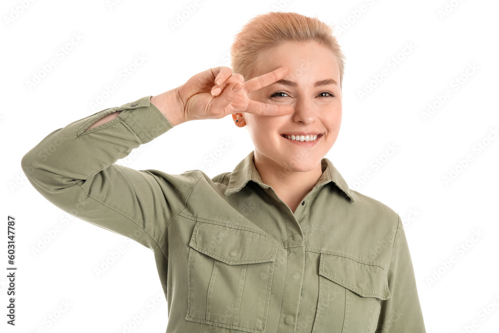 Young woman with short hair showing victory gesture on white background Young woman with short hair showing victory gesture on white background