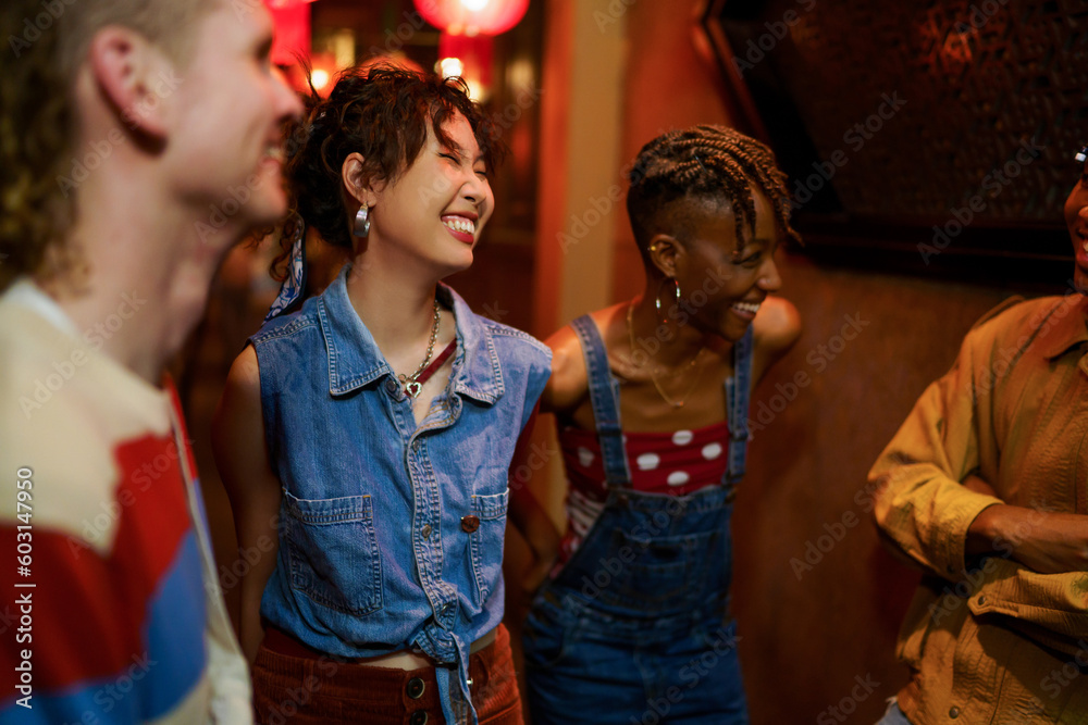 Hipster Asian woman laughing with friends Hipster Asian woman laughing with friends