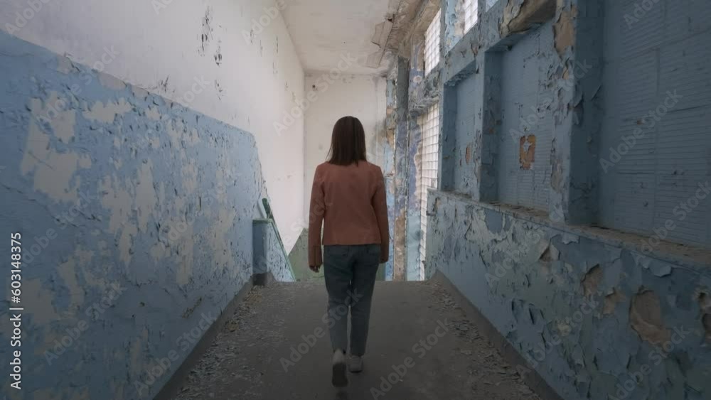 Woman walking on stairs of abandoned school. Gross Friedrichsdorf. Koenigsberg Woman walking on stairs of abandoned school. Gross Friedrichsdorf. Koenigsberg
