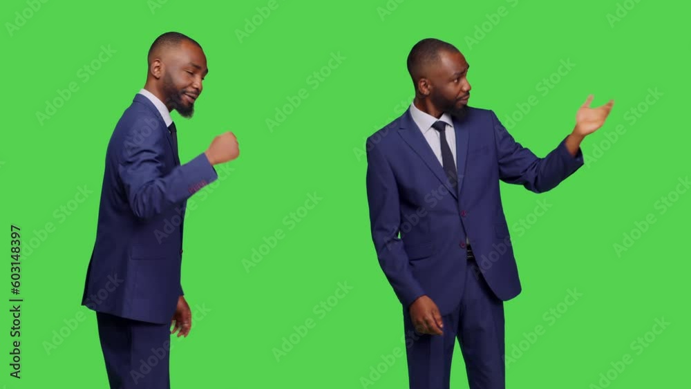 Corporate manager in suit asking someone to come over, calling over people to join standing over greenscreen backdrop. Young man working as businessman and feeling confident in studio. Corporate manager in suit asking someone to come over, calling over people to join standing over greenscreen backdrop. Young man working as businessman and feeling confident in studio.
