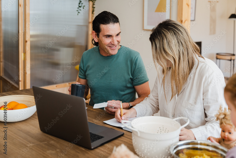 Cheerful Couple Paying Bill At Home Cheerful Couple Paying Bill At Home