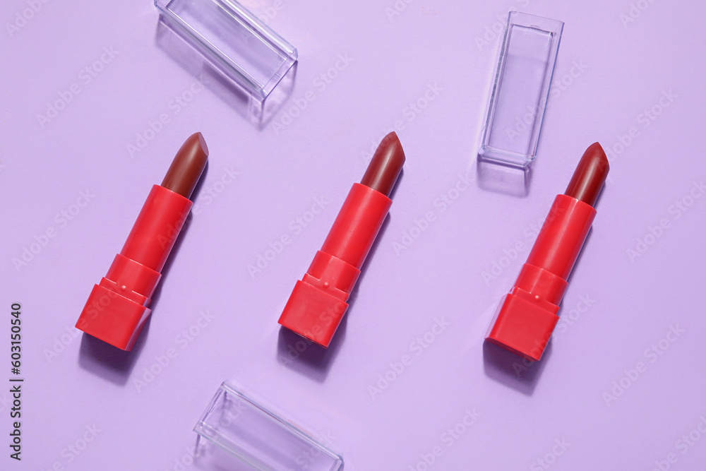 Red lipsticks on lilac background Red lipsticks on lilac background