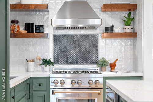 Quadro su tela White square tiled kitchen corner surrounded by Kitchen appliances, two shelves, and a book