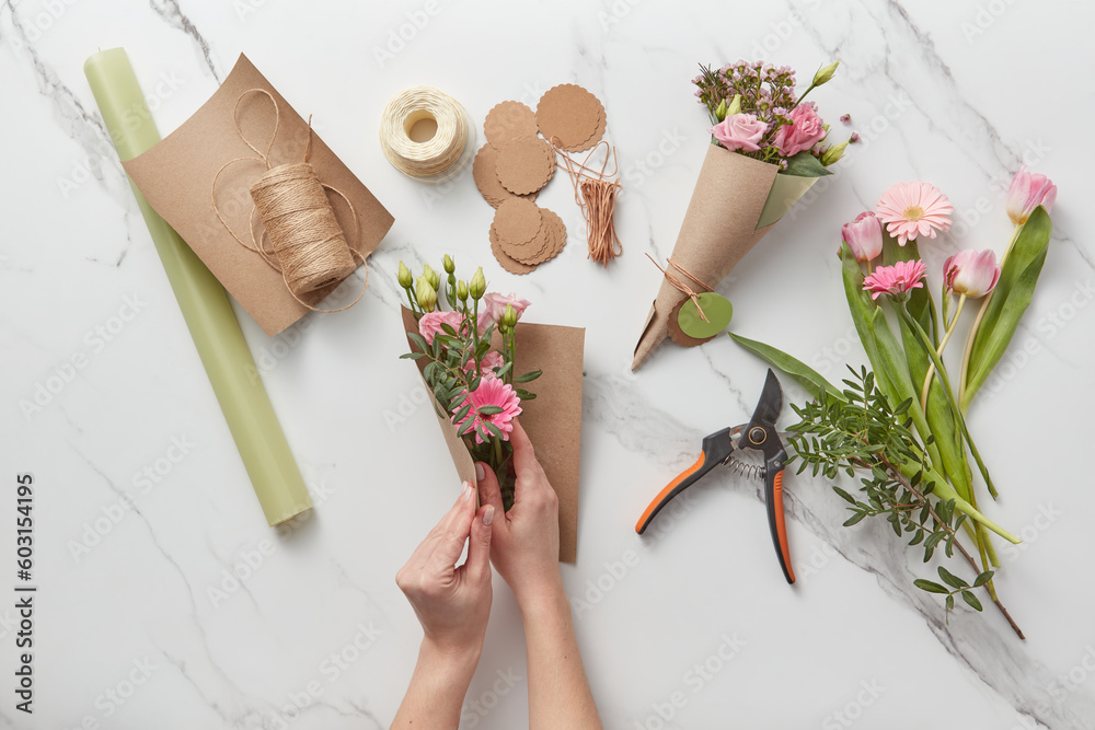 Woman working on pink spring bouquets. Woman working on pink spring bouquets.
