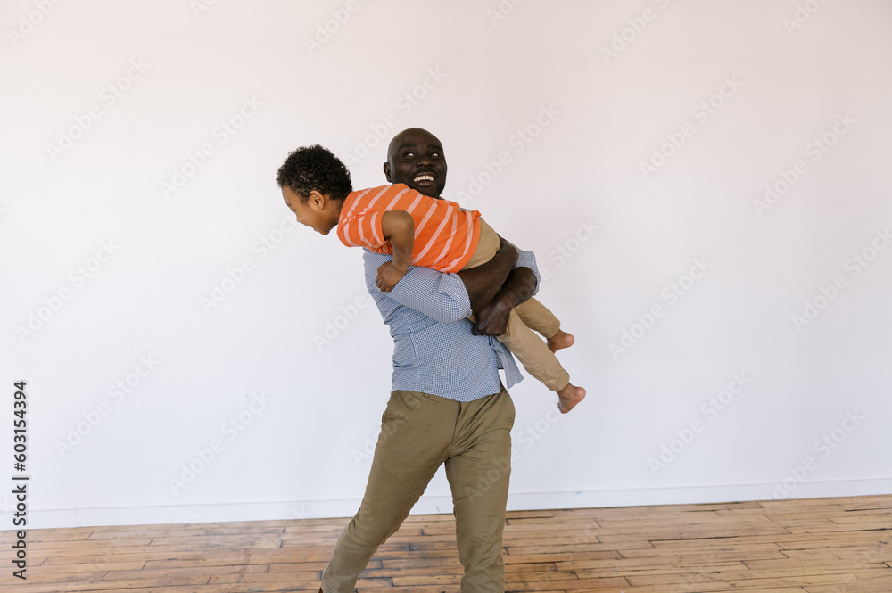 father and son playing and being goofy together indoors father and son playing and being goofy together indoors