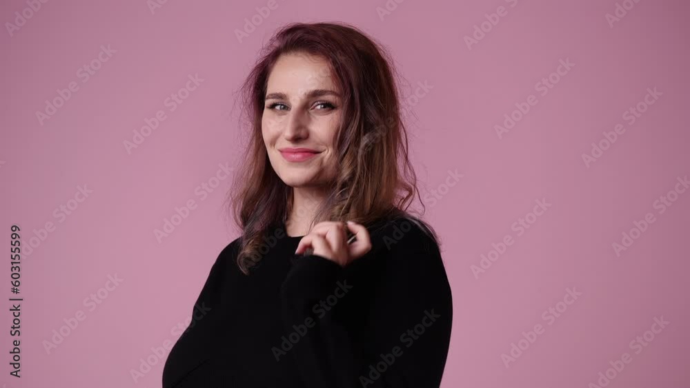 4k video of one cute woman which waving her hair over pink background. 4k video of one cute woman which waving her hair over pink background.
