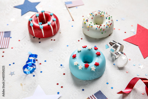 Composition with donuts, USA flags and confetti on white table, closeup. Independence Day celebration