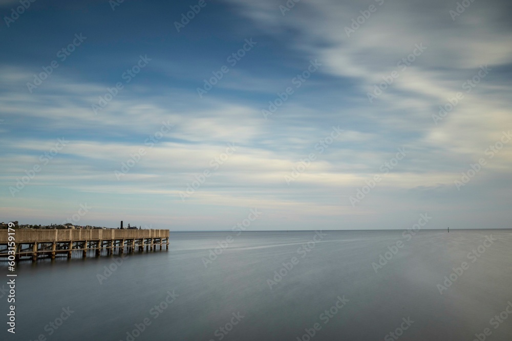 A landscape of the ocean with a wooden structure in the foreground