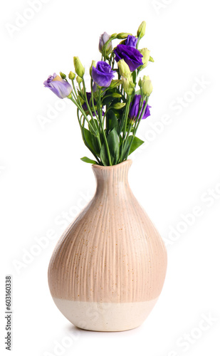 Vase with eustoma flowers on white background