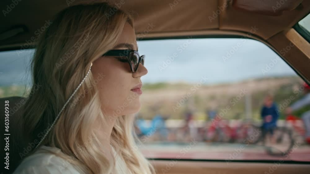 Attractive lady driver riding auto in sunglasses closeup. Girl driving highway Attractive lady driver riding auto in sunglasses closeup. Girl driving highway