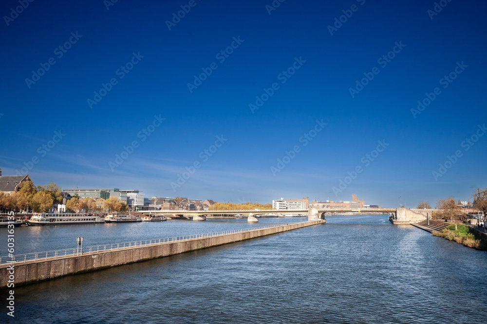 Panorama of Maastricht Waterfront on the Meuse Maas river with a focus on sint wilhelminabrug or Wilhelmina Bridge, in autumn, during a sunny afternoon. Maastricht is a dutch city in the netherlands i