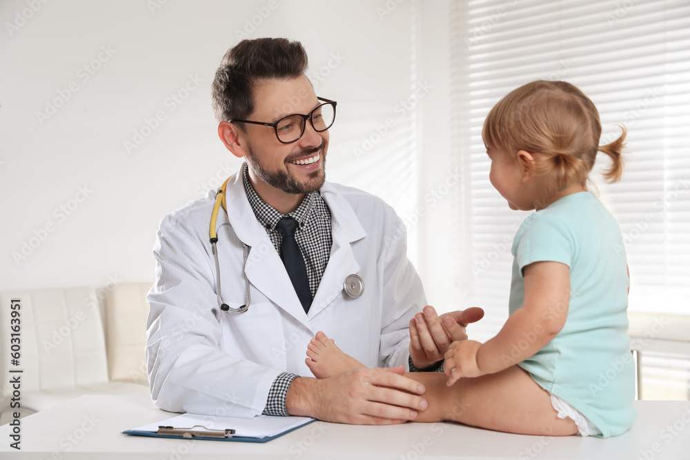 Pediatrician examining cute little baby in clinic Pediatrician examining cute little baby in clinic