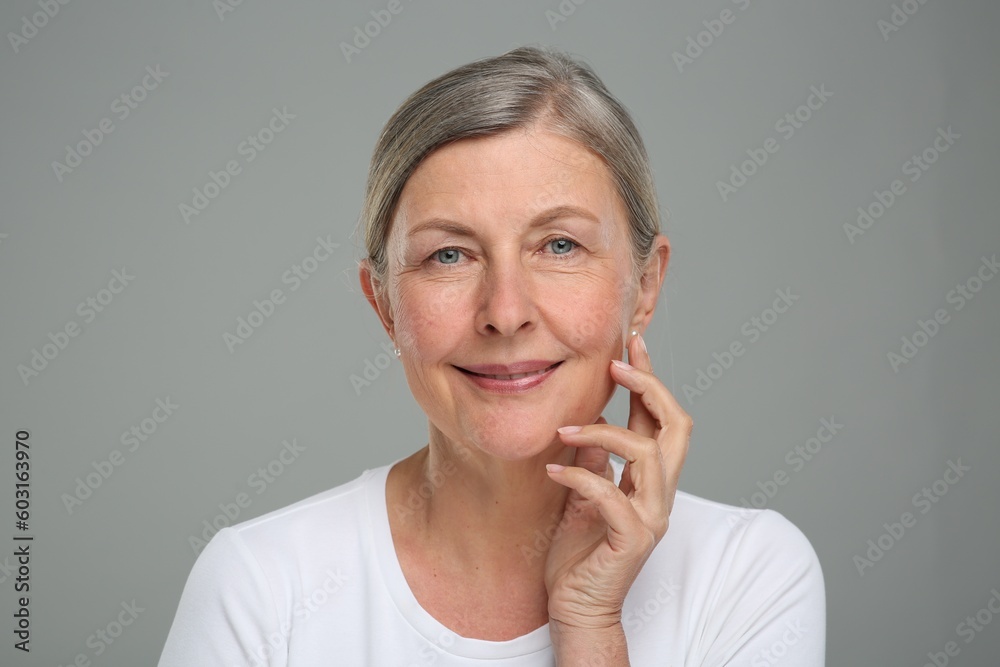 Portrait of senior woman with aging skin on grey background. Rejuvenation treatment Portrait of senior woman with aging skin on grey background. Rejuvenation treatment