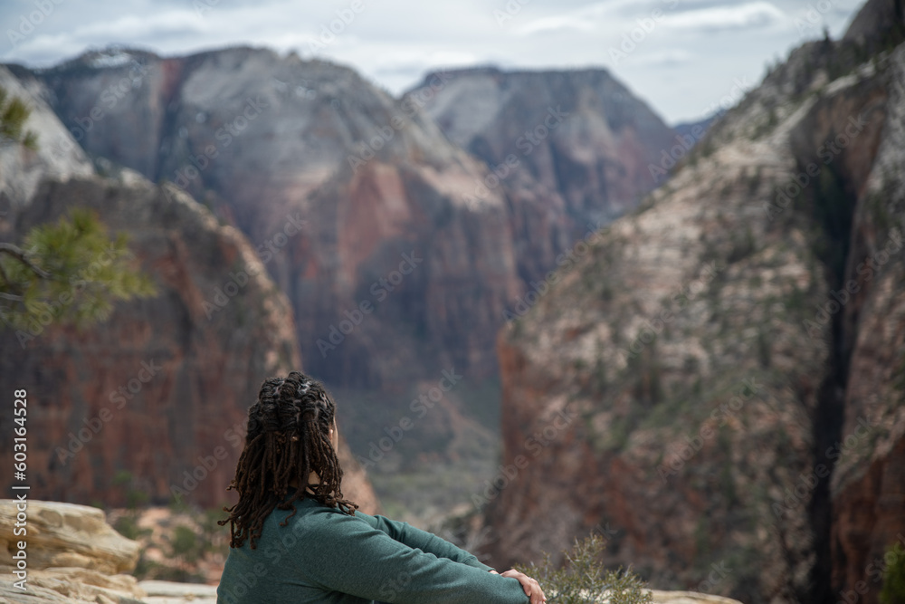 A man looking out at the view of Zion National Park