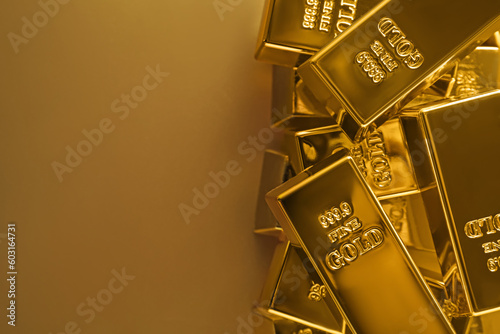 Many shiny gold bars on color background, flat lay. Space for text