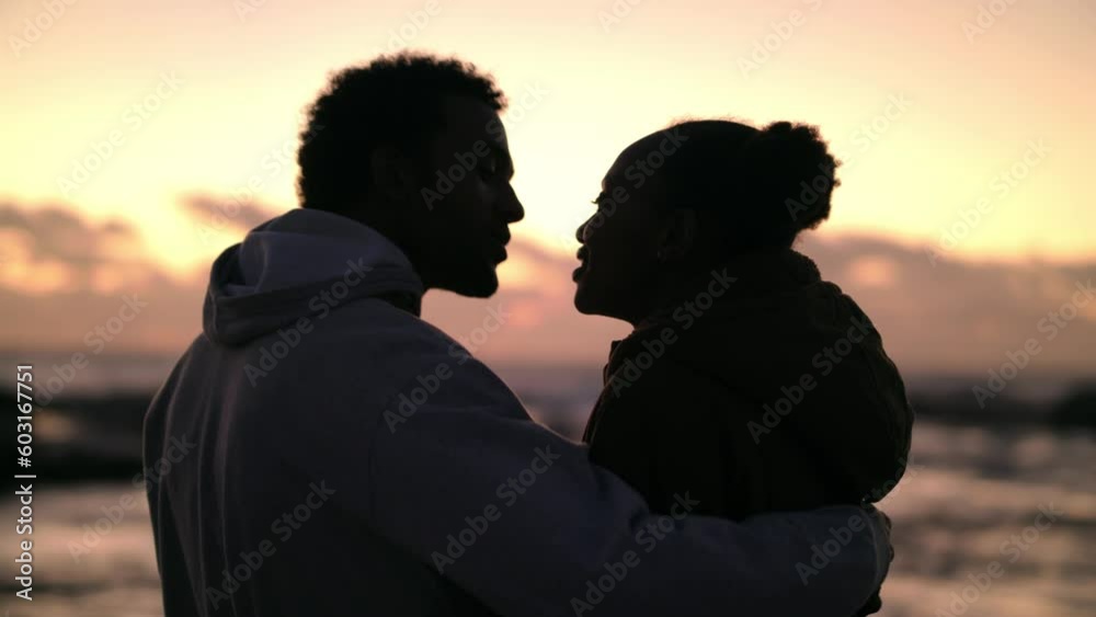 Hug, kiss and sunset with black couple at beach for love, summer break or romantic date. Bonding, affection and peace with happy man and woman in embrace for relax, destination or wellness vacation Hug, kiss and sunset with black couple at beach for love, summer break or romantic date. Bonding, affection and peace with happy man and woman in embrace for relax, destination or wellness vacation