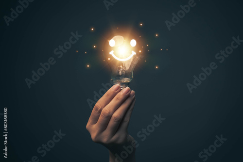 Glowing light bulb in hand, idea search concept Creativity from information trade in the internet world, marketing, business ideas and target groups.