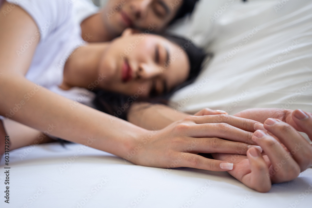 Asian attractive young couple lying down on bed to sleep in bedroom. Asian attractive young couple lying down on bed to sleep in bedroom.