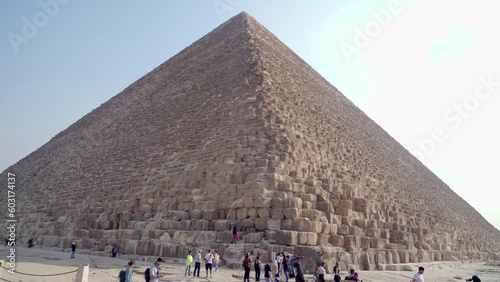 Giza, Egypt. December 2022. Panoramic view of the Great Pyramid of Giza. Some tourists admire the place and take photos. They are considered one of the seven wonders of the world.