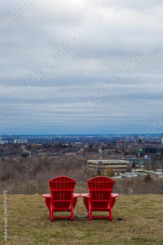 Red chairs on top of a hill 