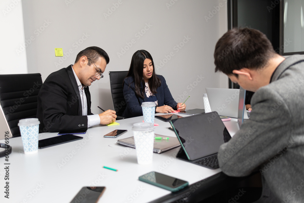 business team teamwork writing ideas for brainstorm in a meeting room, mixed group of businessmen and businesswomen business team teamwork writing ideas for brainstorm in a meeting room, mixed group of businessmen and businesswomen