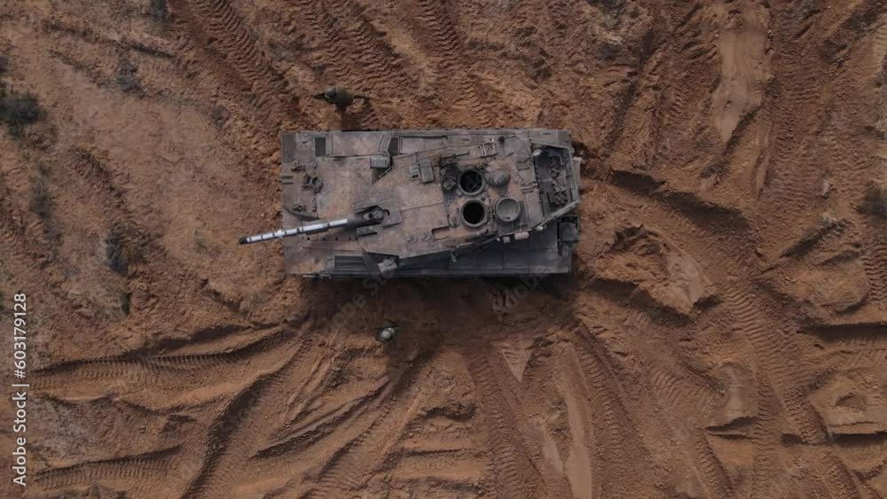 Soldiers walking by the tank in attack formation, aerial overhead view